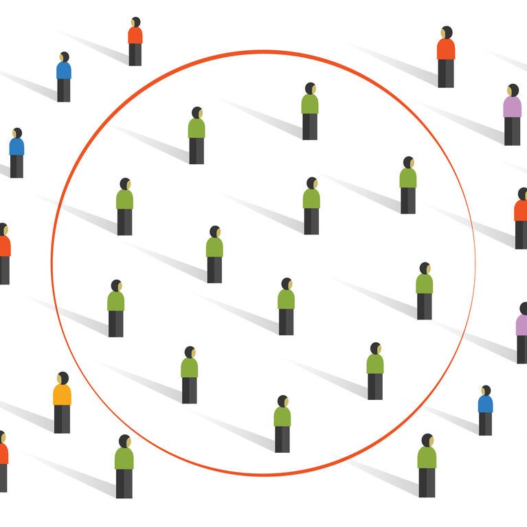 Image of a variety of people wearing different shirt colors with a lot of people wearing green shirts in the center with a red circle surrounding them.