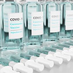 Vaccine vials and shots labeled "COVID-19"