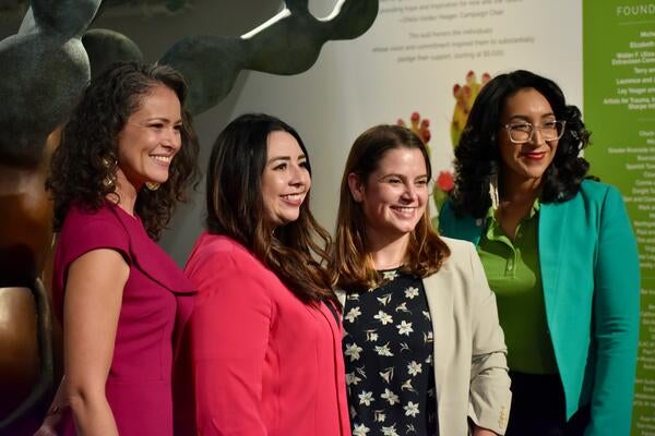 Four women smiling for a picture