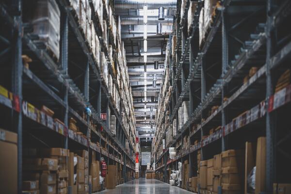 image of warehouse with a lot of shelves and boxes in the horizon