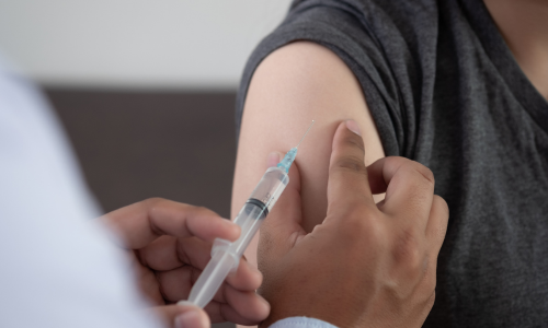 A person getting a shot in a medical office